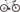 Cykel i titanium med SRAM Rival AXS, Principia Gravel 22, set fra siden med grusvej i baggrunden.